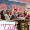 Robert Downey Jr. ringing the opening bell at the NYSE, along with Iron Man and the Marvel staff