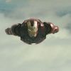 a post-battle Iron Man flies