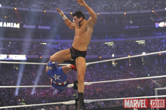 Cody Rhodes delivers a knee to the face of Rey Mysterio