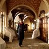 Elektra walking through her childhood home