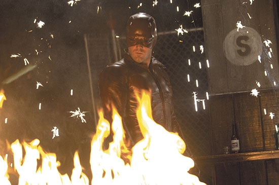 Daredevil standing behind fire