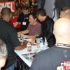 Jon Favreau and Robert Downey jr. sign some autographs